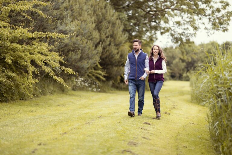 a man and a woman walking down a path